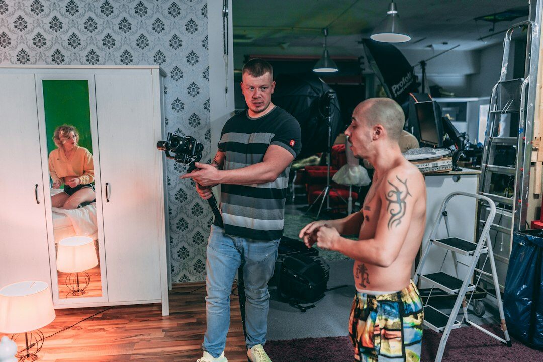 Small team of filmmakers reviewing footage together in a studio