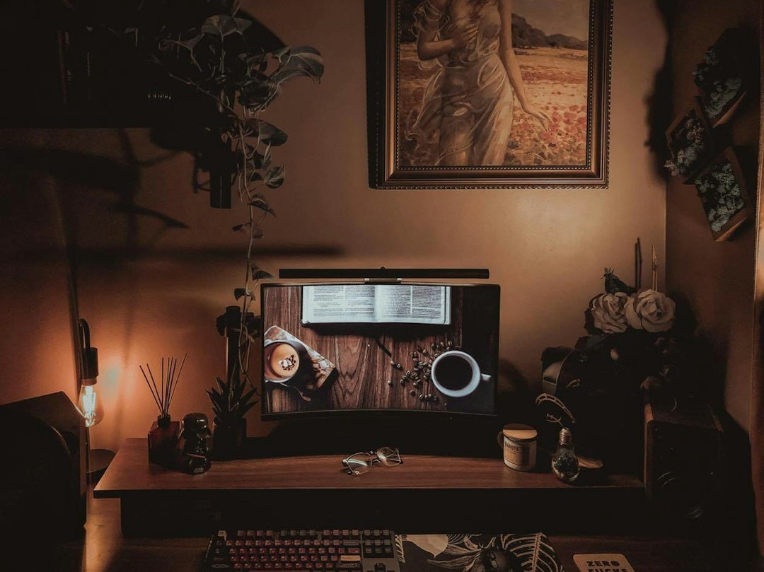Video editor working on a film timeline at a desk with two monitors